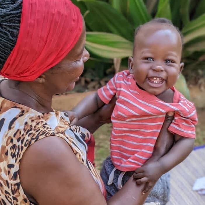 foster mother with young child in Uganda