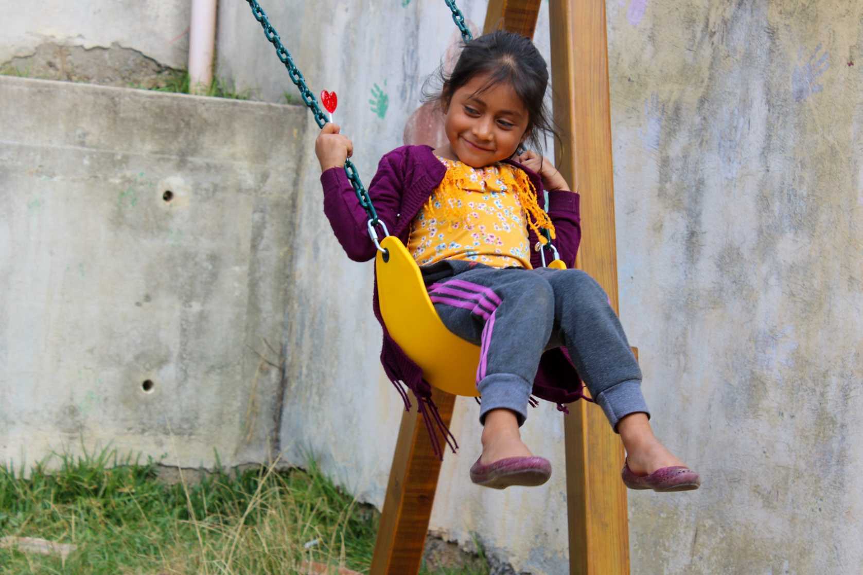 Girl Smiling Contentedly on a Swing