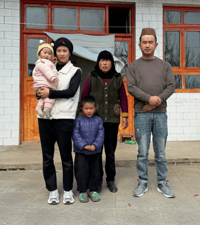 A family in China, consisting of a mother, father, grandmother, young boy, and baby girl